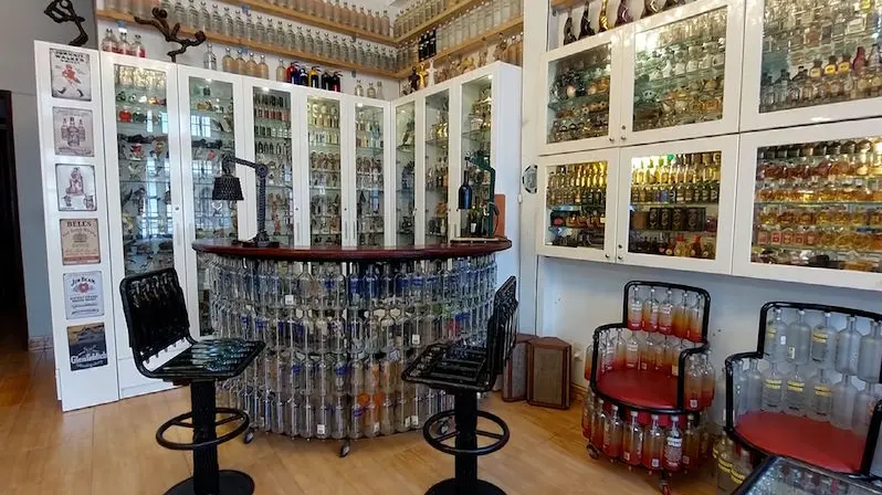 The man makes furniture out of glass bottles which would otherwise end up in a landfill
